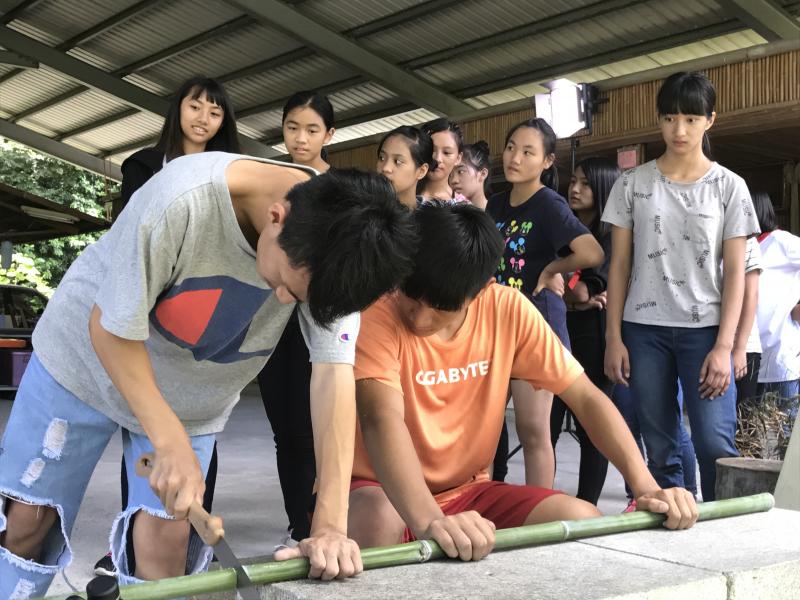 利用手鋸將竹子鋸成所需大小
