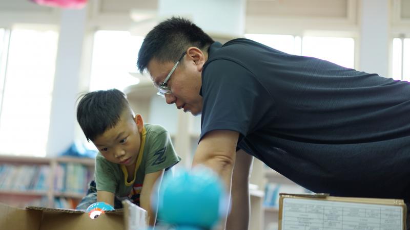 <p>竹山DOC結合甫啟用的鯉魚社區共讀站推廣長幼共學活動，使用DASH機器人結合紙箱障礙關卡，建立小大學員的共學趣味。</p>