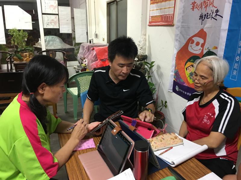 學員看著老師示範怎麼操作平板