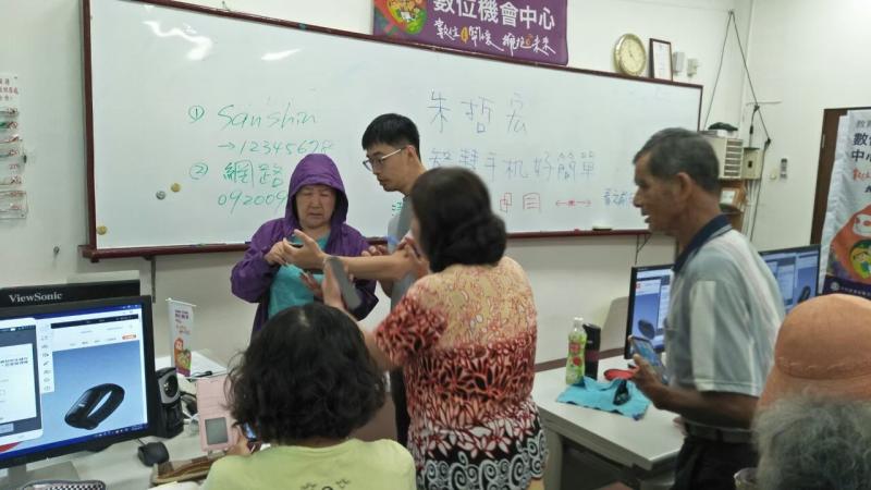 講師在極力協助因為身穿紫色外套的學員的問題。