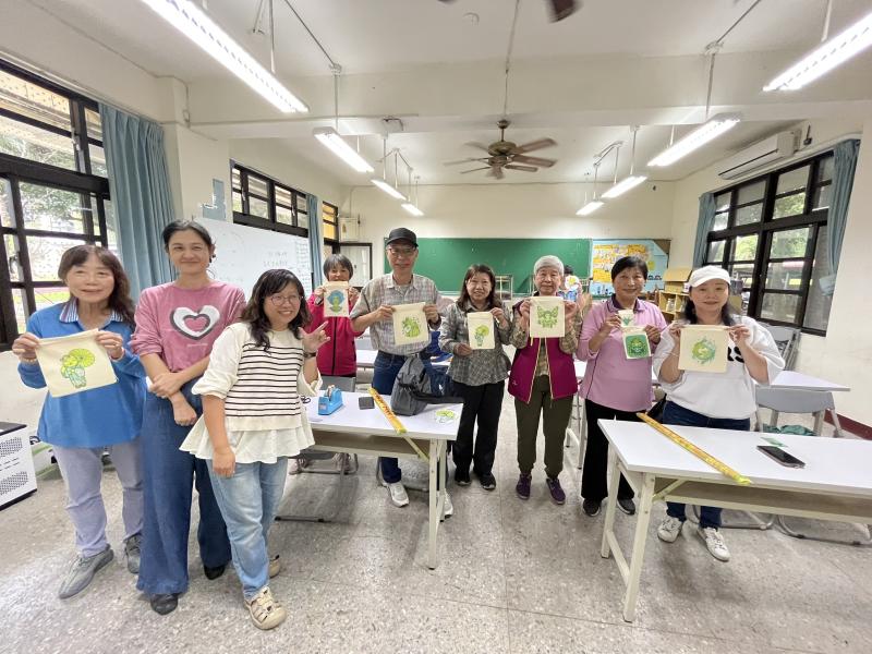 學員們拿著自己完成的作品合影