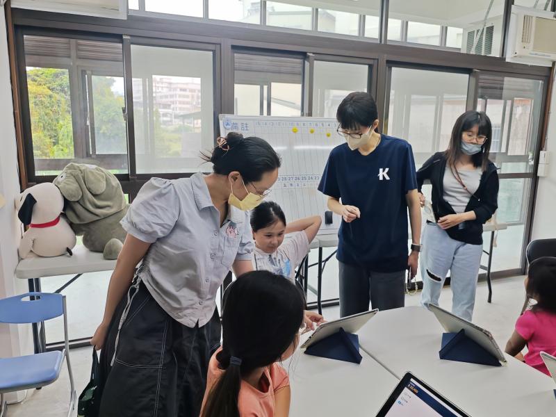 家長與孩子們共同操作「DOC理財小管家」數位工具。在面對生活開銷抉擇時，大人們引導孩子點擊「理智必需品」與「衝動享樂品」。透過真實的數據反饋，讓孩子理解父母平時持家與分配預算的不易，進而建立起家庭理財的共識。