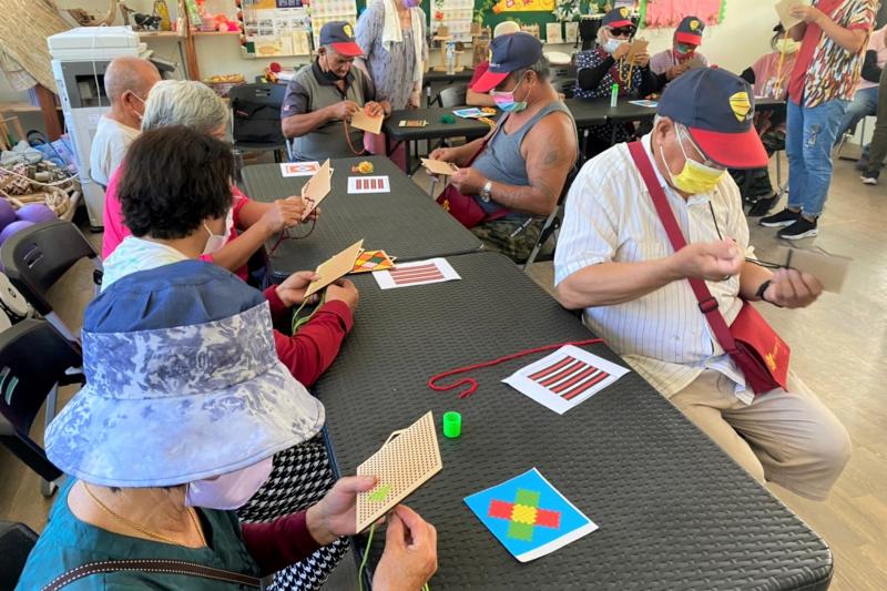 學員們將自己設計的圖像繡在十字繡洞洞板上