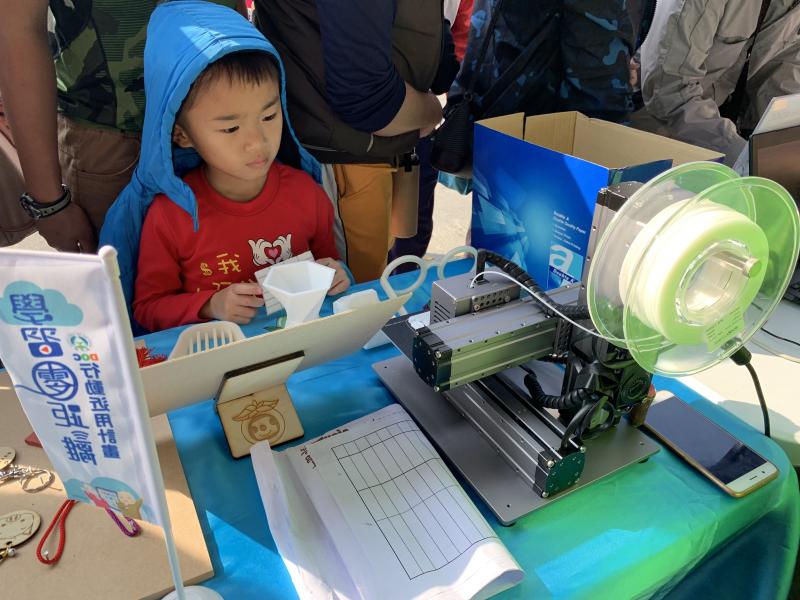 燕巢DOC於2/17至永安天文宮宣導推廣，桌上的一部3D列印機，吸引小男孩目不轉睛的直盯著