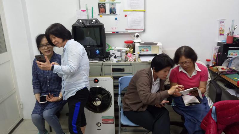 學員以智慧手機學習課堂的教學內容，彼此互動熱絡。