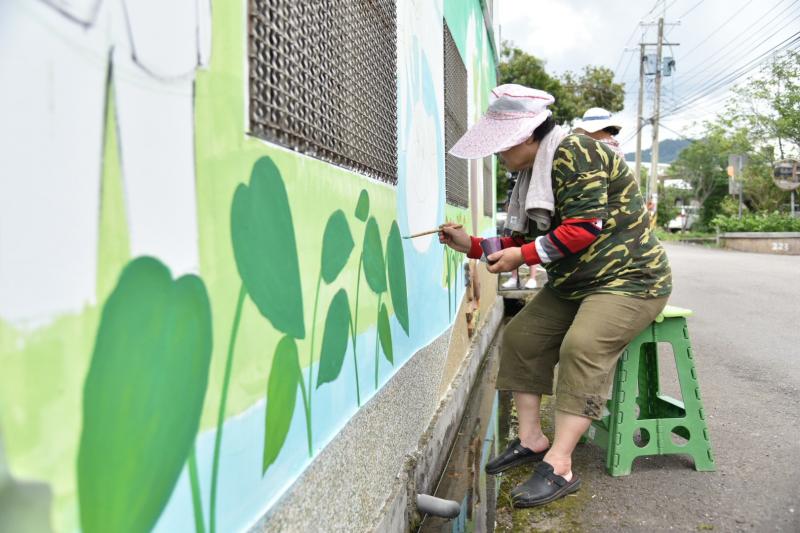 學員描繪在地生活的藝術故事牆。