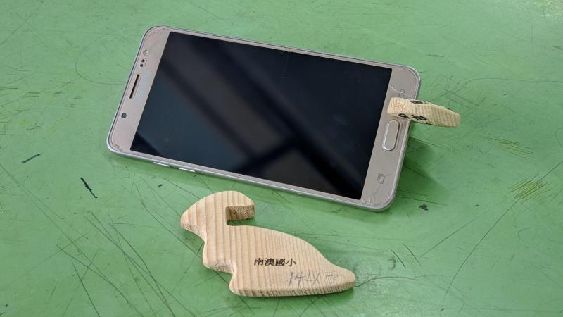 南澳DOC雷射雕刻課程，製作可當刮痧板使用的手機架，雷雕「南澳國小」字樣