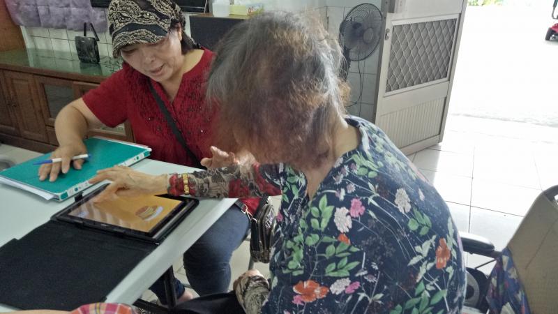 志工協助教導學員玩鬆餅塔遊戲