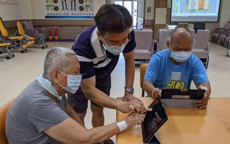 講師細心的指導長輩如何使用平板