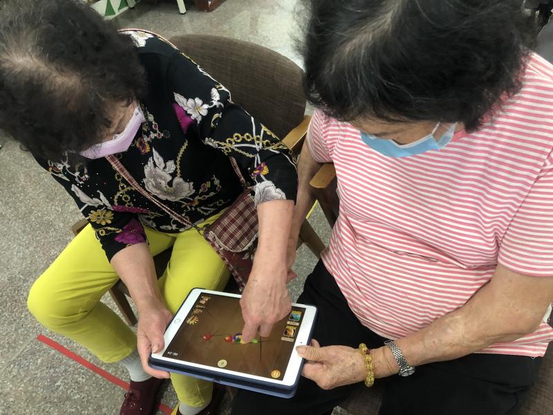 學員相互協助使用平板