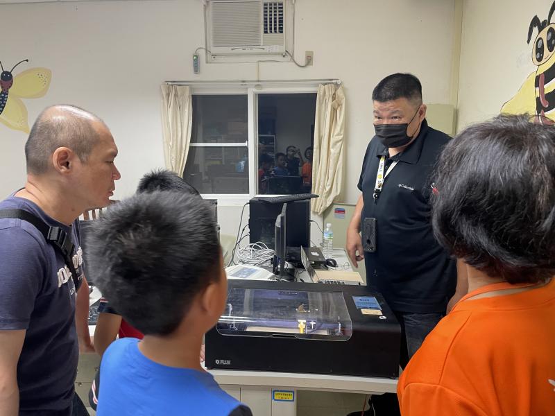 學員與導師在旁觀看作品雷雕情況