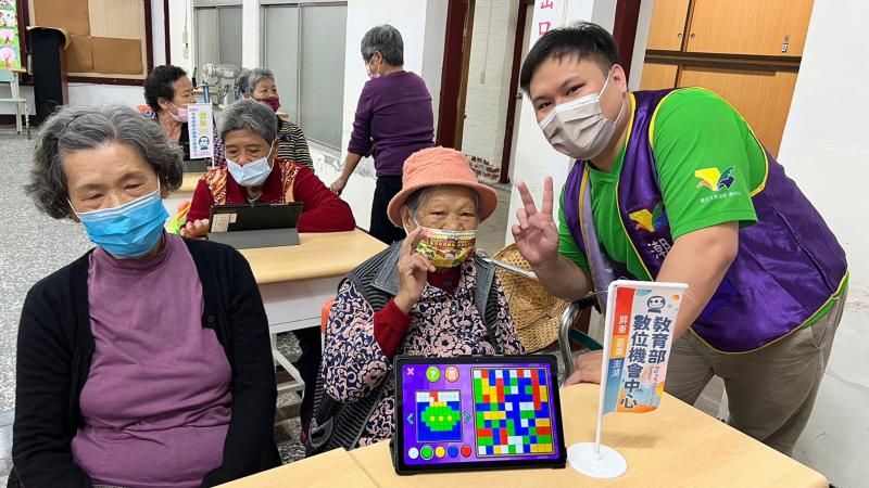 幫可愛的四春關懷據點 拍照。做兔年新年賀年卡-透過平板學習數位延緩衰老益智遊戲 四春的陳阿公和阿嬤說：啾口愛的。粉開心