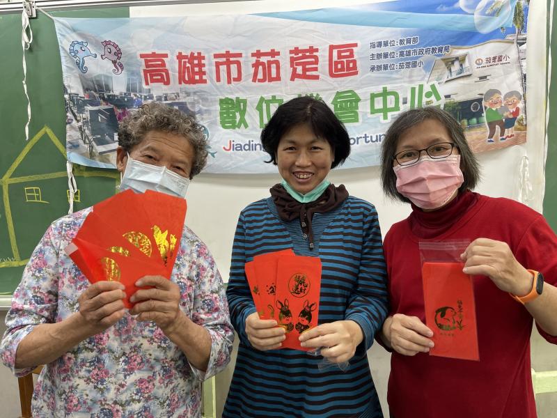 拿著自己設計的圖稿印刷出的紅包袋學員們開心極了