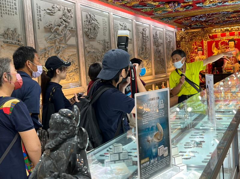 學員認真聽張老師講述媽祖神蹟故事並用相機做成記錄