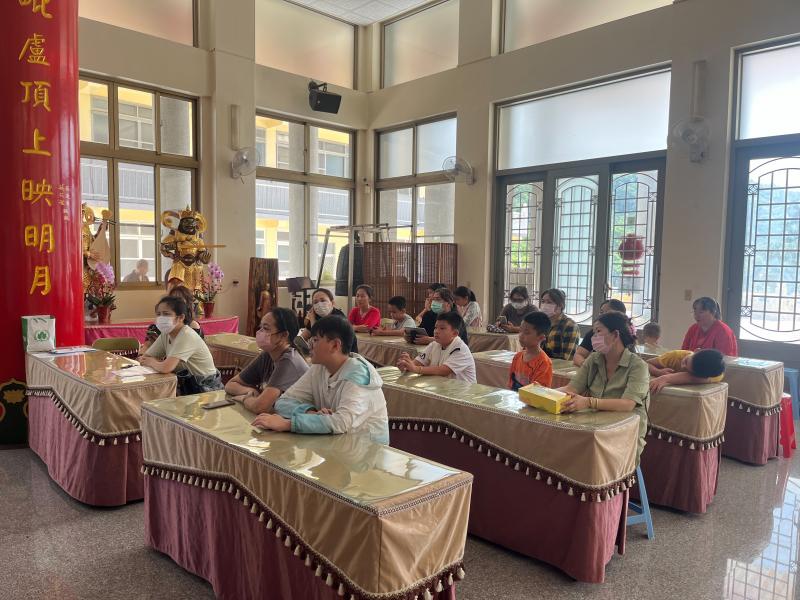 老師播放影片給姊妹看，姊妹和小孩共同一起學習。