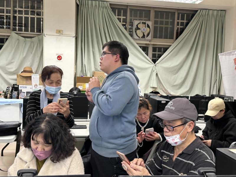 學員認真滑手機圖片生成畫面及操作技巧有問題時老師從旁協助.