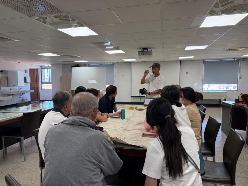 老師實際展示數位相機，並一一講解不同的功能。