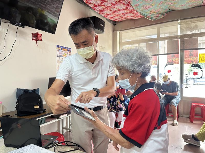 學生跟老師一起操作手機