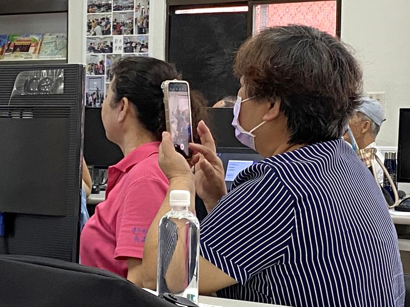 學員擔心遺忘操作步驟，專注以手機拍攝紀錄講師的投影示範畫面