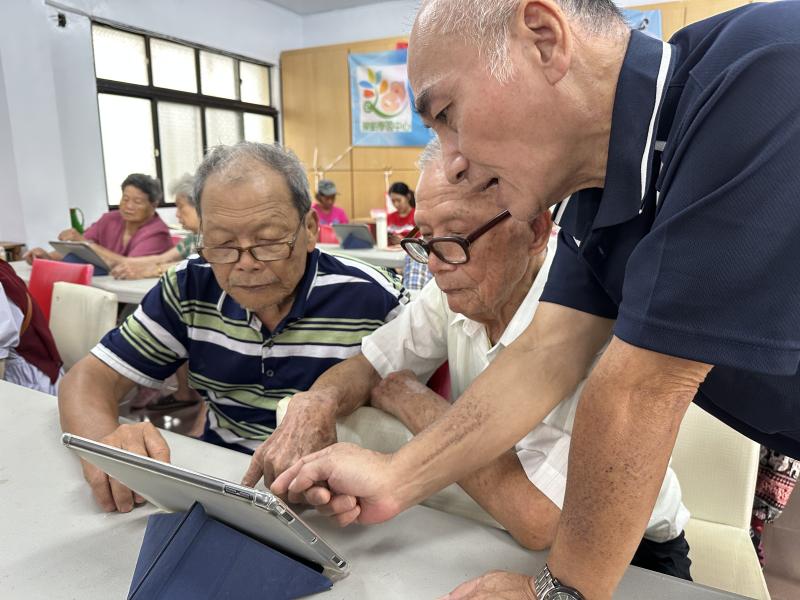 學員互相協助操作平板