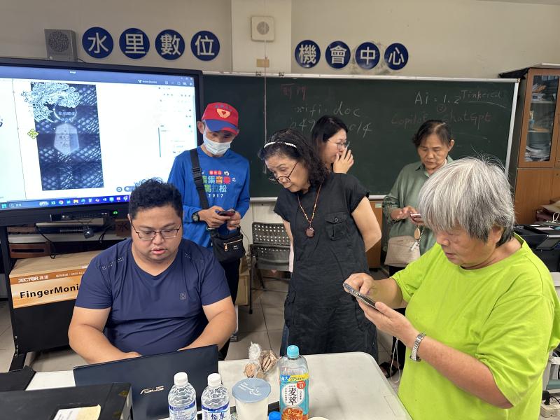 學員看著老師筆電呈現出雷雕排版的畫面以及在等候手機操作上問題待發問的同學.