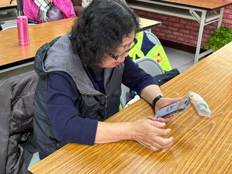 石潭社區活動中心內，多位長者坐在長桌前，人手一台平板電腦，正在專注地練習觸控操作與數位應用。